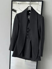 Asymmetric draped collar peplum blazer with structured shoulder in ivory