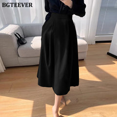 A-line mid-length split skirt with pockets and high waist