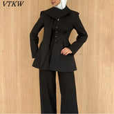 Asymmetric draped collar peplum blazer with structured shoulder in black