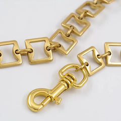Gilt square chain waist belt with brass tassel in old gold