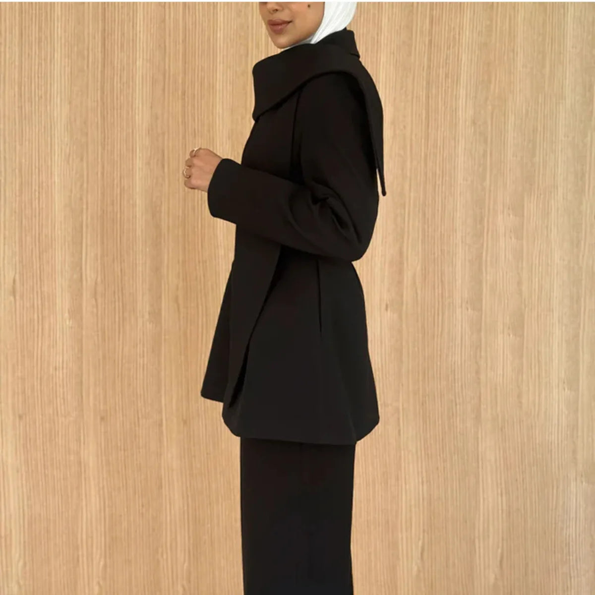 Asymmetric draped collar peplum blazer with structured shoulder in black